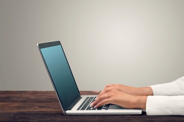 businessman hand on laptop computer in office