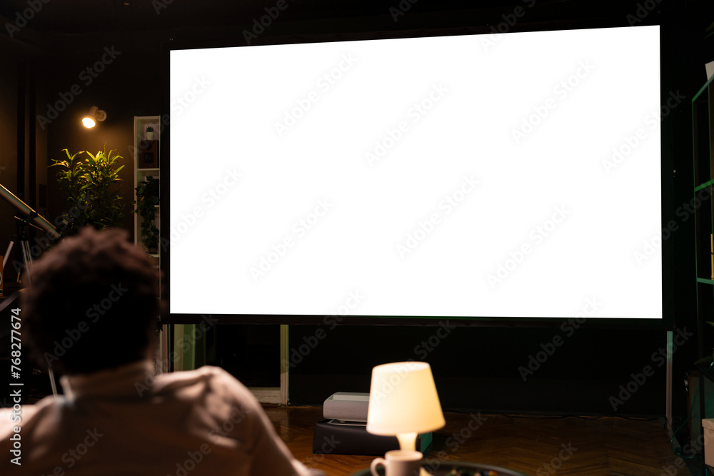 Poster person using isolated screen large smart tv to binge series on subscription based streaming services