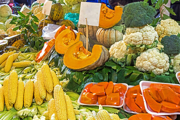 Raw organic ripe vegetables with cut pumpkin on market stall outdoors - 768278084