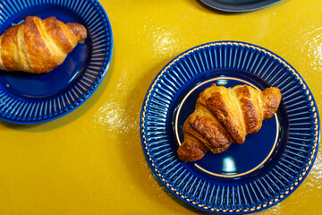 croissant colorful blue yellow flat lay in a bakery on a plate