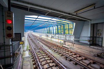 Double railway line with converging image of platform at Sr.Roubado metro station, Lisbon...