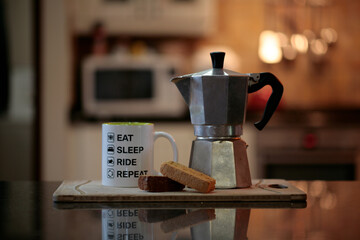 Coffee maker with biscuit and mug - obrazy, fototapety, plakaty