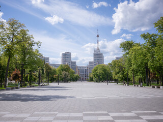 empty freedom square with green trees and derzprom building in kharkiv city