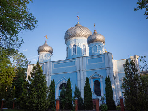 exterior of light blue colored chruch with golden domes in kharkv city