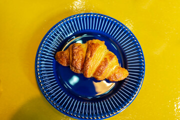 croissant colorful blue yellow flat lay in a bakery on a plate