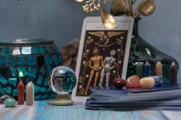 Cartomancy - Pendulum On Blurred Altar With Defocused Tarot Cards.