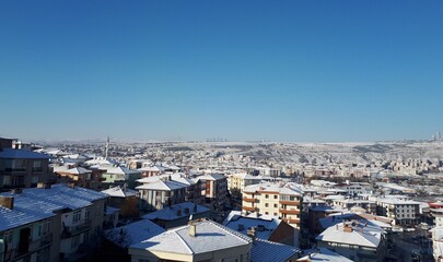 Snow on the rooftops and blue sky