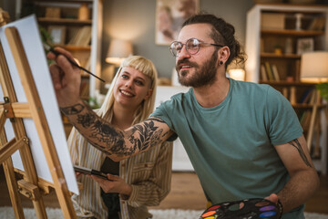 couple man and woman paint on canvas on easel at home leisure hobby