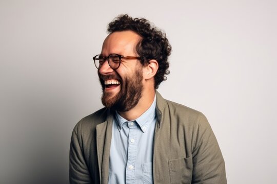 Portrait of a handsome hipster man laughing and looking at camera.