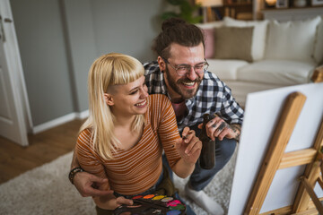 couple man and woman paint on canvas on easel at home leisure hobby