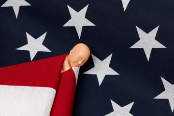 Fetus swaddled in American flag. Abortion rights, reproductive law and abortion access concept. - obrazy, fototapety, plakaty