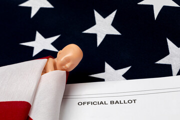 Fetus swaddled in American flag with election ballot. Abortion rights, reproductive law and...