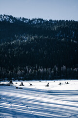 Snow covered frozen lake with mountains in the background