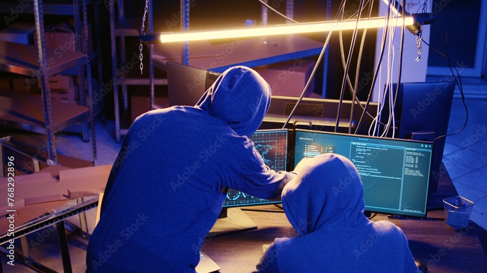 Poster spies working together in secret hideout, doing valuable data theft by hacking governmental websites