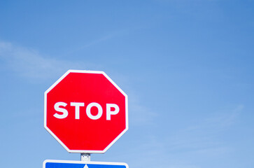 isolated stop sign with blue sky background, road safety concept