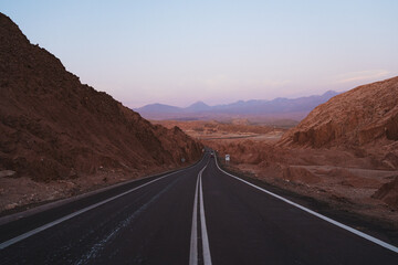 Landscape shot during sunset of road crossing mountains in Atacama desert, Chile
