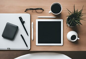Top view of a minimalist desk with a tablet and pens on it