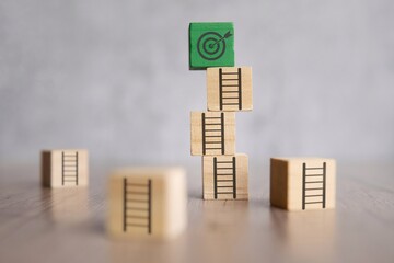 Wooden block staircase with uneven steps leading up to a target board. Obstacles to achieve goals...