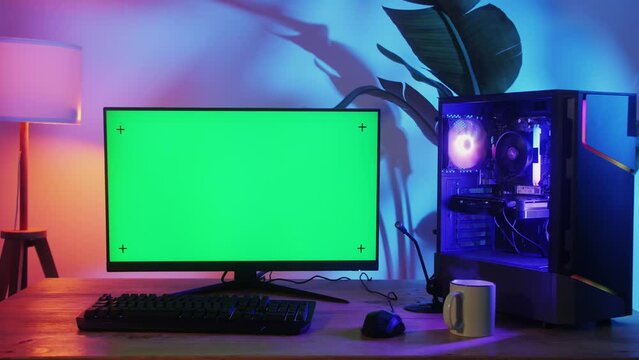 Computer with chroma key green screen on monitor. Gamer man playing in popular video games. Programmer or hacker coding a code and working in networks, cyberspace. Digital software, mobile app