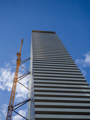 Naklejka premium Construction of a high-rise building in Asia. Construction industry in Georgia. Resort town. Concrete frame. Modern high-rise buildings