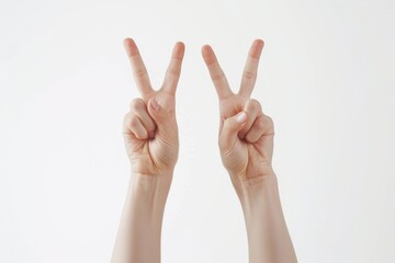 White hands show the iconic peace sign with V-shaped two fingers, a symbol of harmony and non-violence