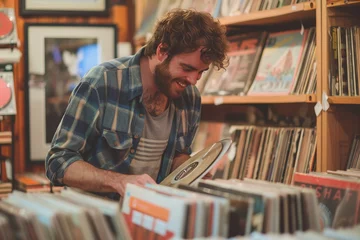 Afwasbaar Fotobehang Muziekwinkel A young, music enthusiast man explores vintage vinyl records in a retro-style shop