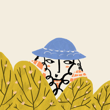 Person in blue hat peeking through yellow bushes
