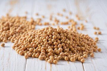 Pile of soybeans on a white wooden table. Heap of organic soybeans on a white wooden table.