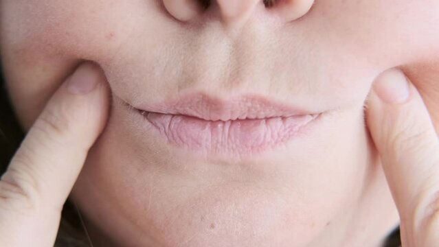 mature woman gently touches face, accepting visible signs aging such wrinkles, sagging skin and changing facial shape with grace and self-love, self-discovery, self-acceptance ages