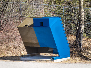 A bear and wildlife proof garbage and recycling disposal box in a forest park area