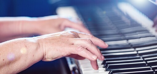 Person fingers on piano key for play music