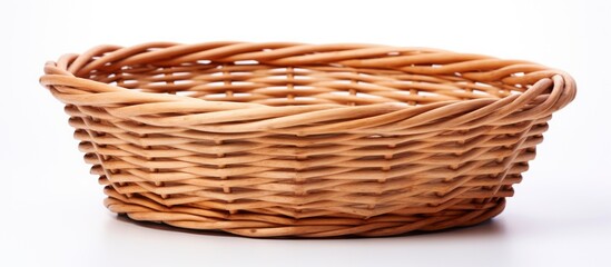 Obraz premium A wicker storage basket made of wood is placed on a white surface, ready to hold ingredients for a delicious baked goods recipe