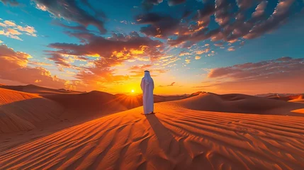 Foto op Plexiglas An Arab man stands alone in the desert, watching the sunset in a moment of reflection © Orxan