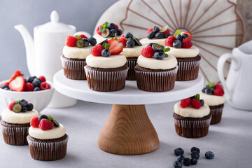 Chocolate cupcakes with vanilla buttercream frosting and fresh berries