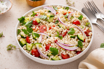 Pearl couscous salad with fresh vegetables and herbs, healthy side dish idea