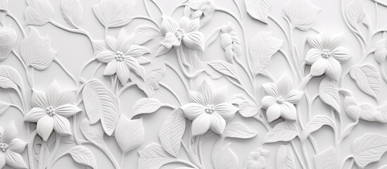 An up-close view of a white wall adorned with various blooming flowers and green leaves, creating a beautiful and vibrant natural display