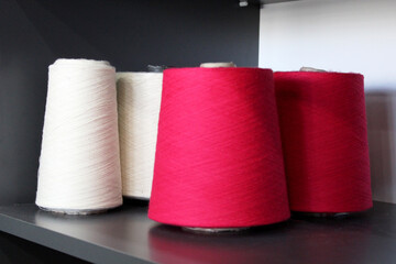 Colorful sewing threads wound on a thread spool. textile