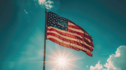 American Flag Flying Proudly Against Blue Sky - obrazy, fototapety, plakaty