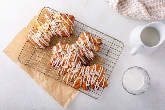 Bear claws pastry drizzled with sugar glaze and topped with almonds