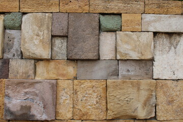 Close-up view of a wall made of several colored natural stones. decor harmony vision.