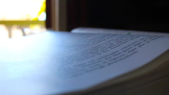 Turning school textbook pages close up 1