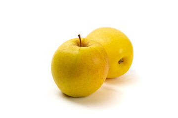 Two ripe yellow Golden Delicious apples isolated on white
