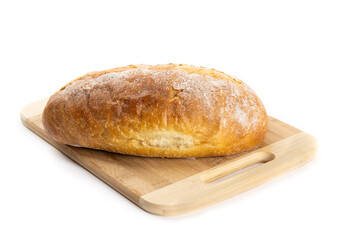 A loaf of artisanal crusty bread on a wooden cutting board isolated on white