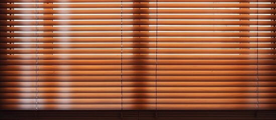 A close-up of a domestic cat sitting by a window with white horizontal blinds, looking outside curiously