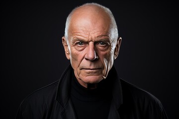 Portrait of an old man with a serious expression. Studio shot.