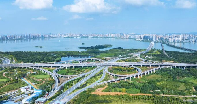 surround aerial time lapse video of the interchange overpass with urban landscape in Jiujiang city, Jiangxi province, China.
