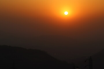 Stunning sunset over hazy mountain landscape