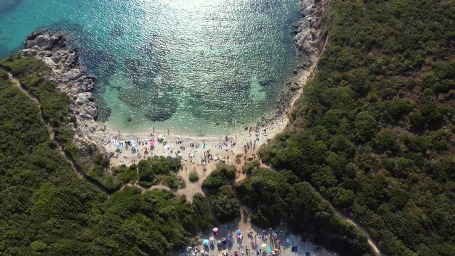Slide Aerial over Crowed Porto Timone Beach, Corfu, Greece