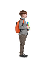 Little schoolboy with backpack and books on white background