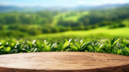 Circle wooden table top with blurred tea plantation landscape against blue sky and blurred green leaf frame Product - obrazy, fototapety, plakaty